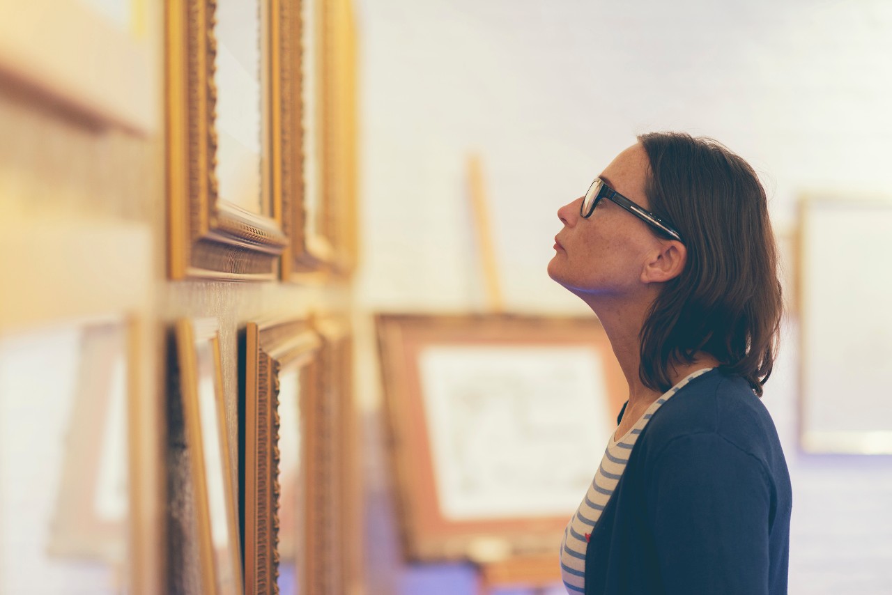 Woman looking at the paintings